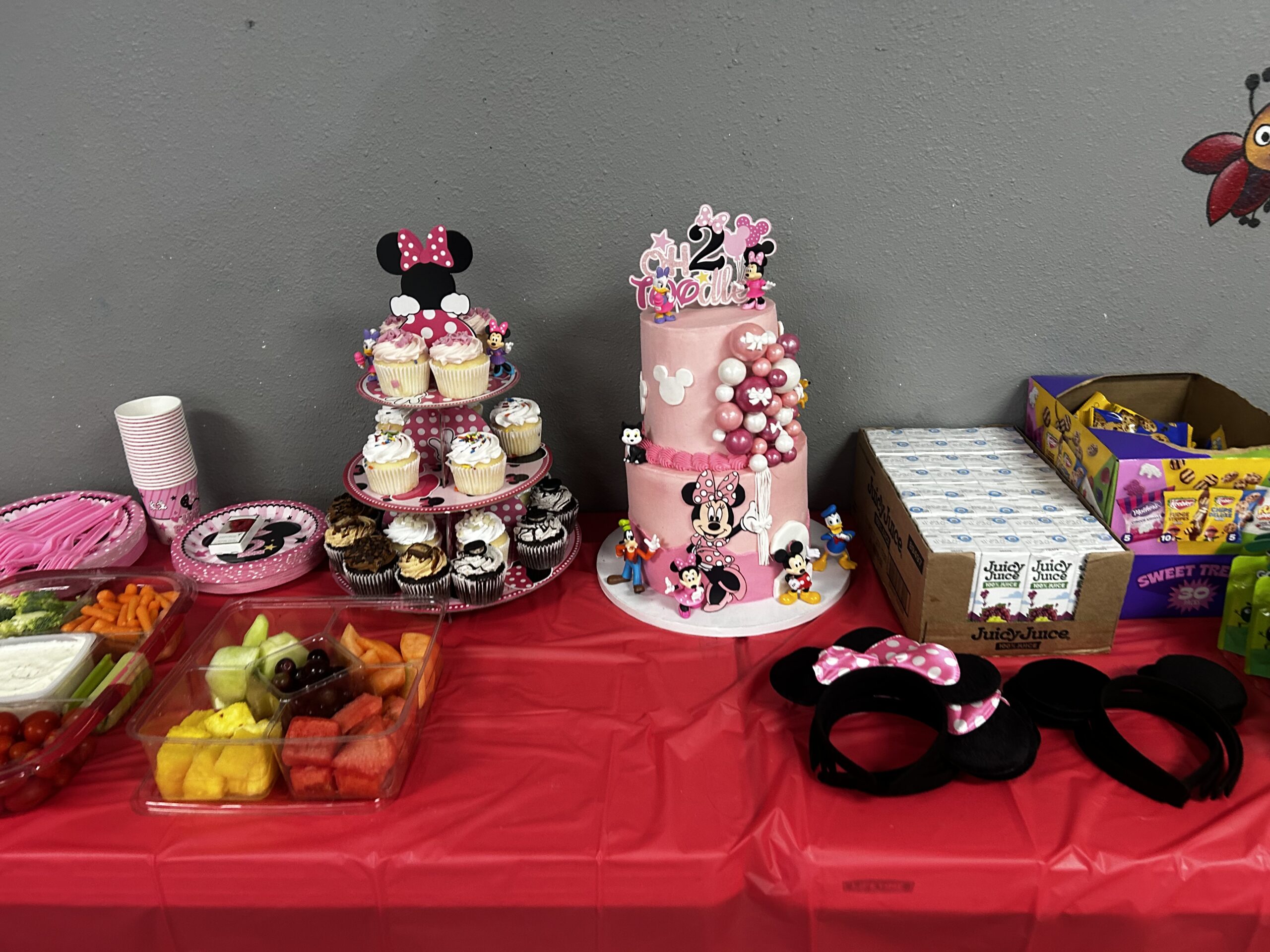 Red Table with cake and food on it.